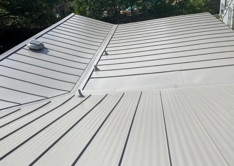 Solar attic fan installed on a metal roof for Roof Ventilation in Del City